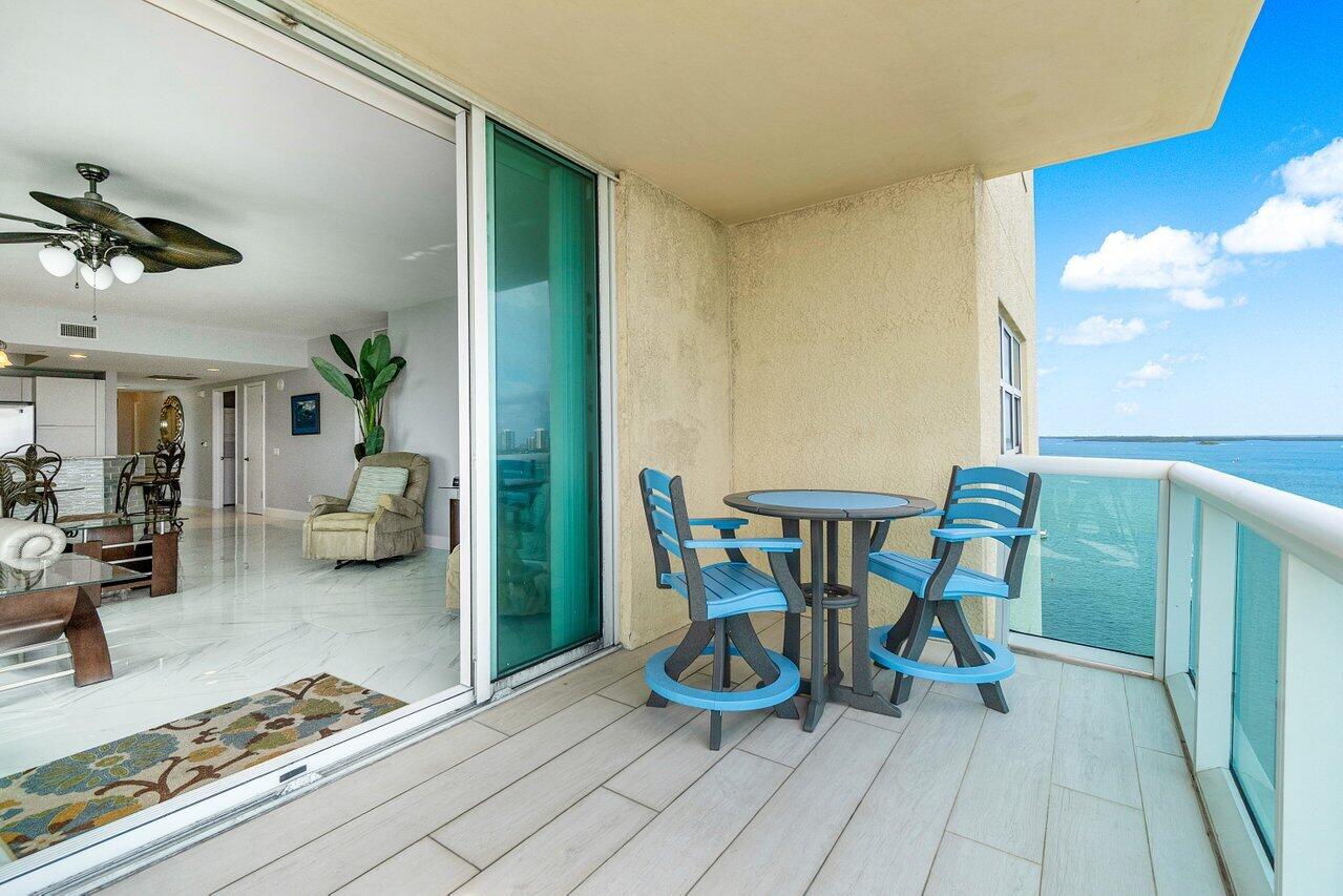 2640 Lake Shore Drive, Unit 1216 Riviera Beach, FL 33404 - Photo 29 of 60 a dining room with furniture and a chandelier