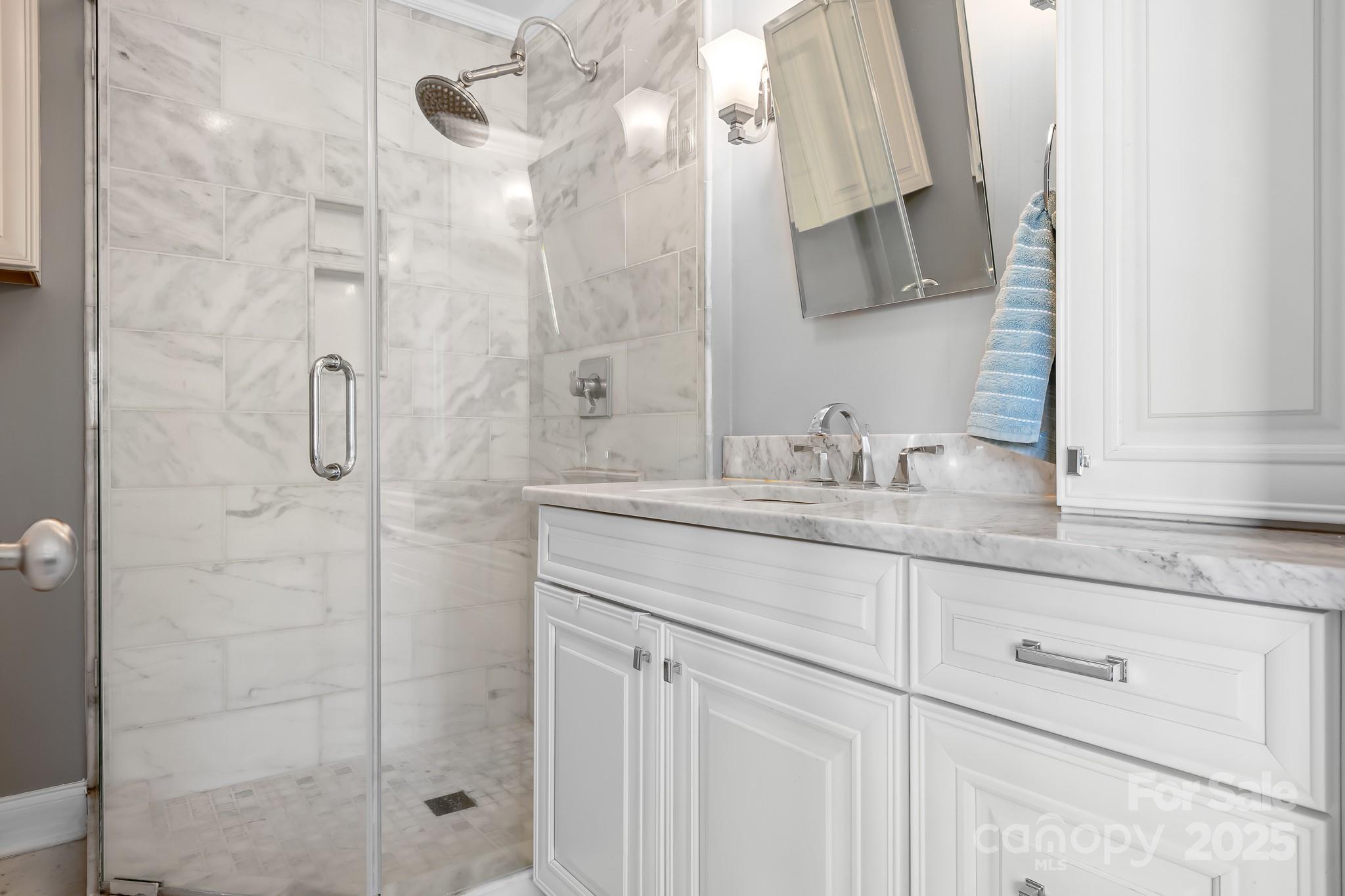 19320 Davidson-Concord Road Davidson, NC 28036 - Photo 14 of 33 a bathroom with a granite countertop shower sink vanity and mirror