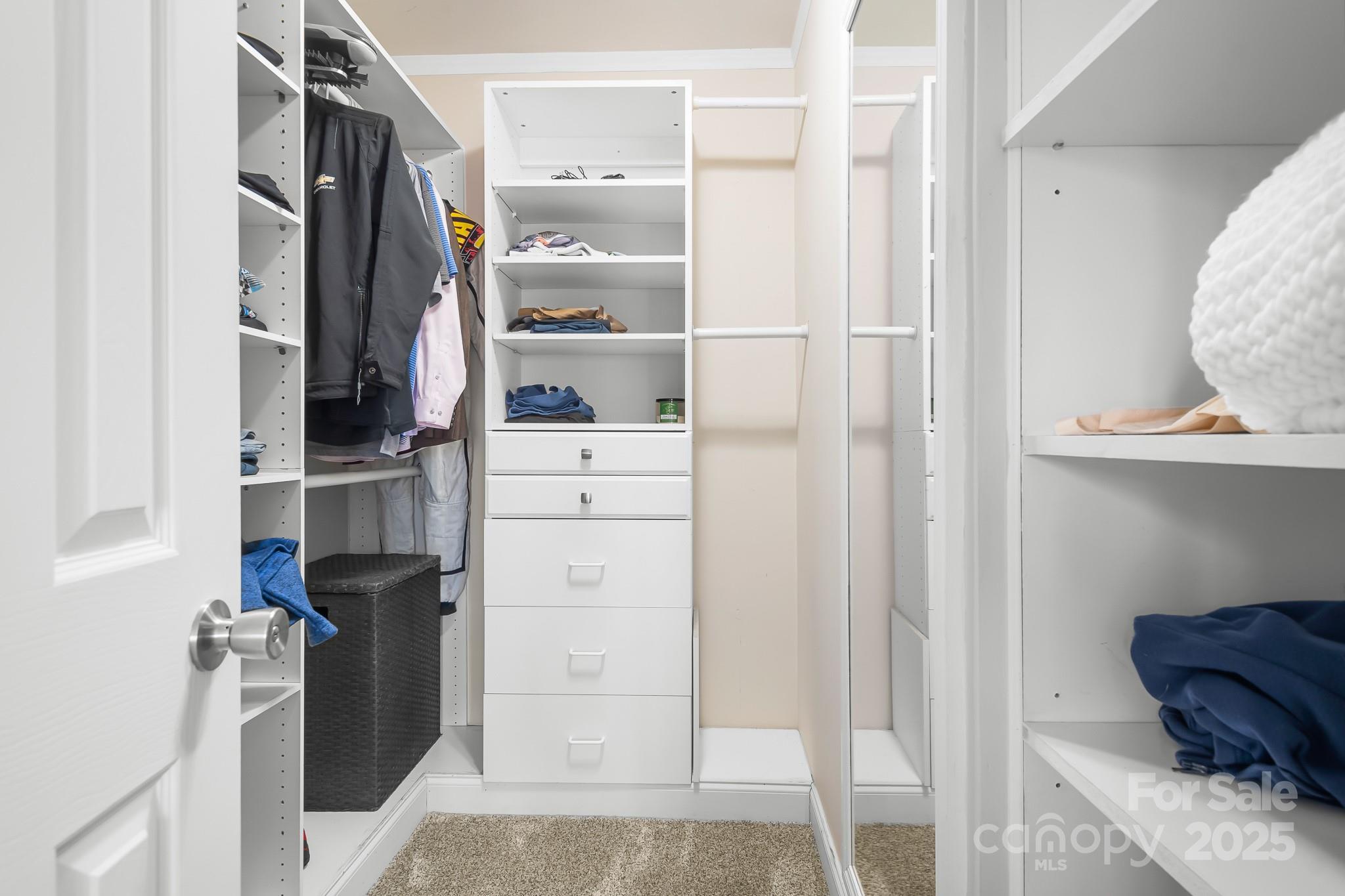 19320 Davidson-Concord Road Davidson, NC 28036 - Photo 15 of 33 a view of walk in closet with clothes and shoes