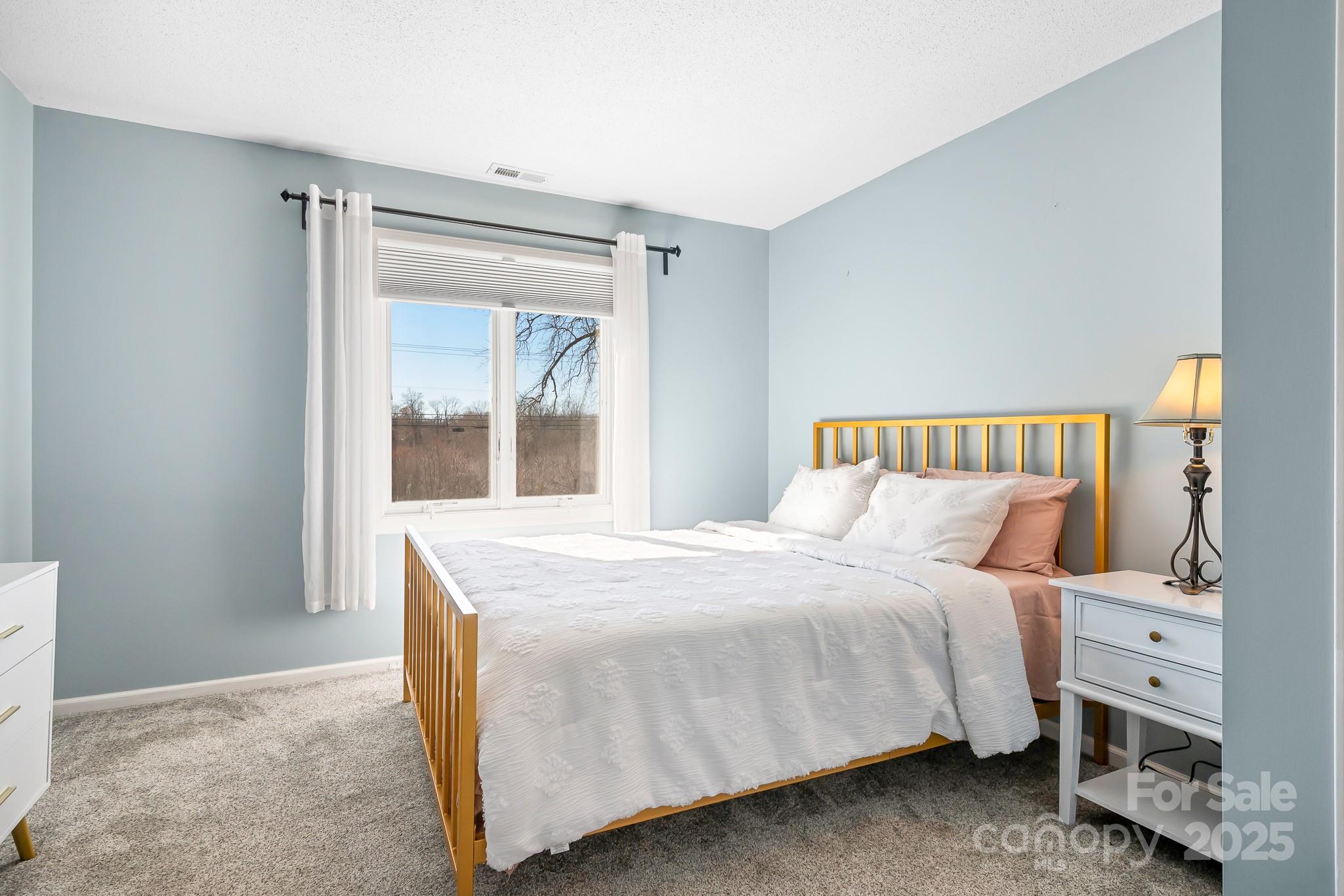 19320 Davidson-Concord Road Davidson, NC 28036 - Photo 16 of 33 a bedroom with a bed and a window