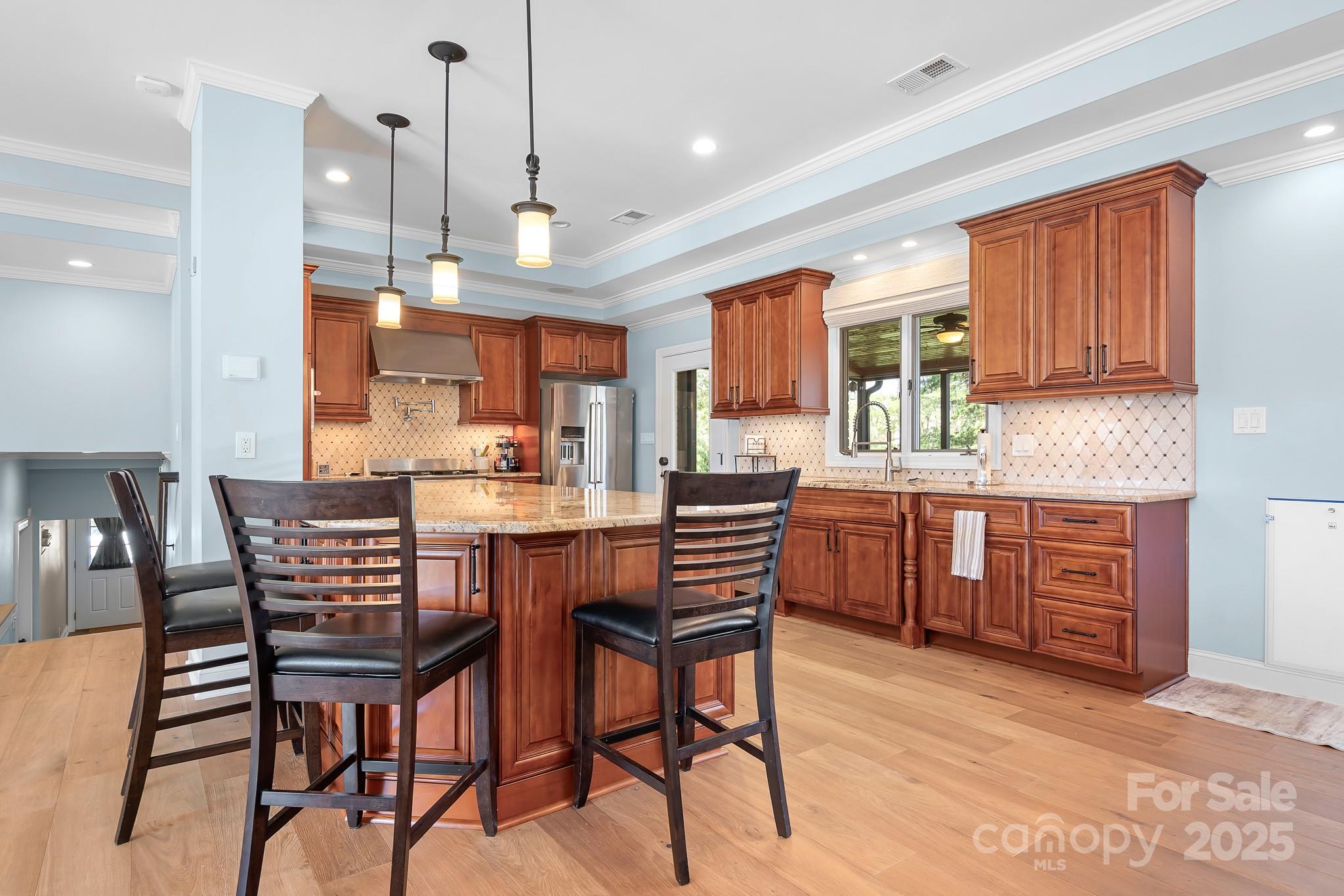 19320 Davidson-Concord Road Davidson, NC 28036 - Photo 7 of 33 a kitchen with a dining table chairs and wooden cabinets