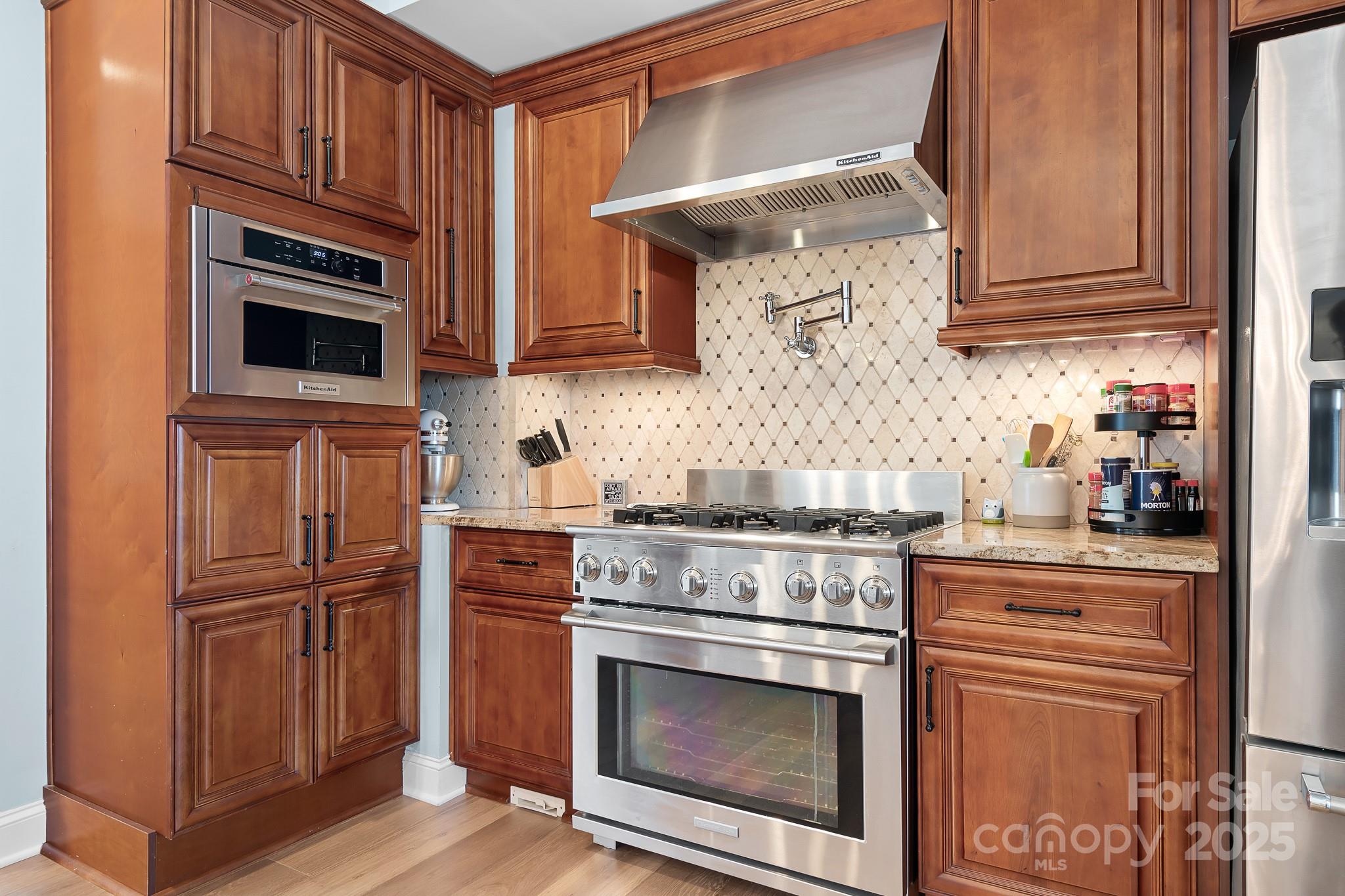 19320 Davidson-Concord Road Davidson, NC 28036 - Photo 10 of 33 a kitchen with stainless steel appliances granite countertop a stove microwave and refrigerator