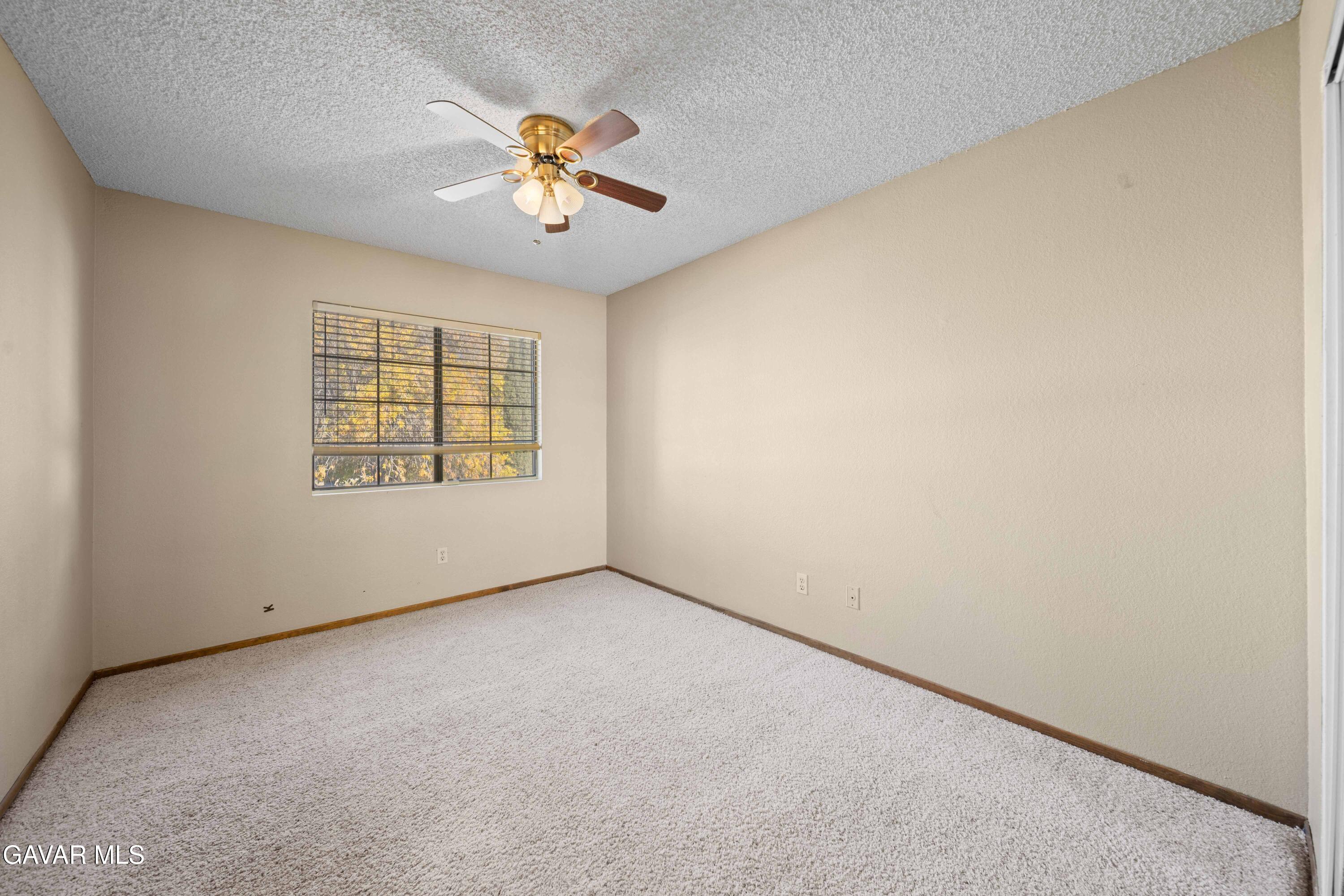 44200 Galion Avenue Lancaster, CA 93536 - Photo 24 of 42 an empty room with windows and fan
