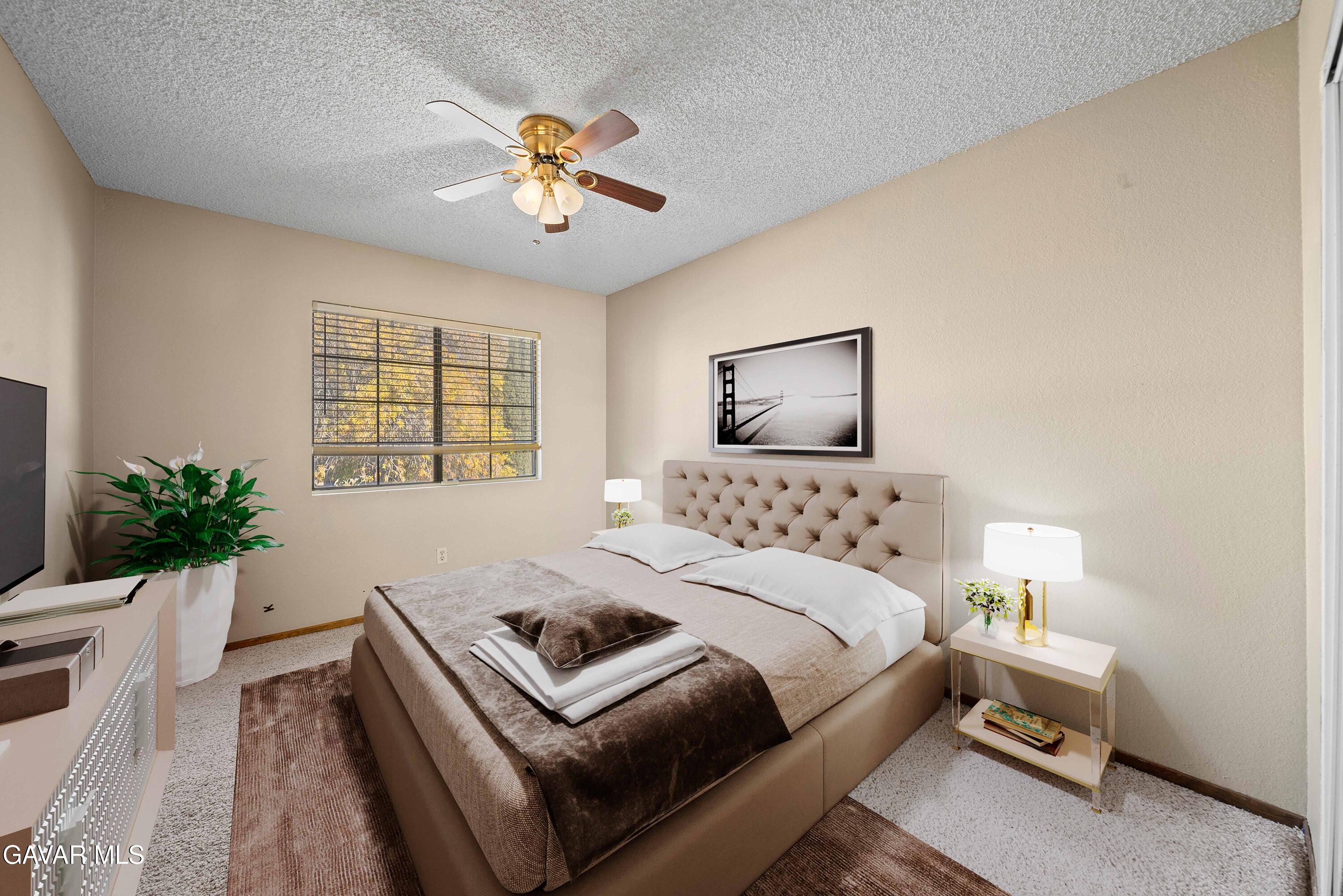 44200 Galion Avenue Lancaster, CA 93536 - Photo 25 of 42 a bedroom with a bed and a chandelier