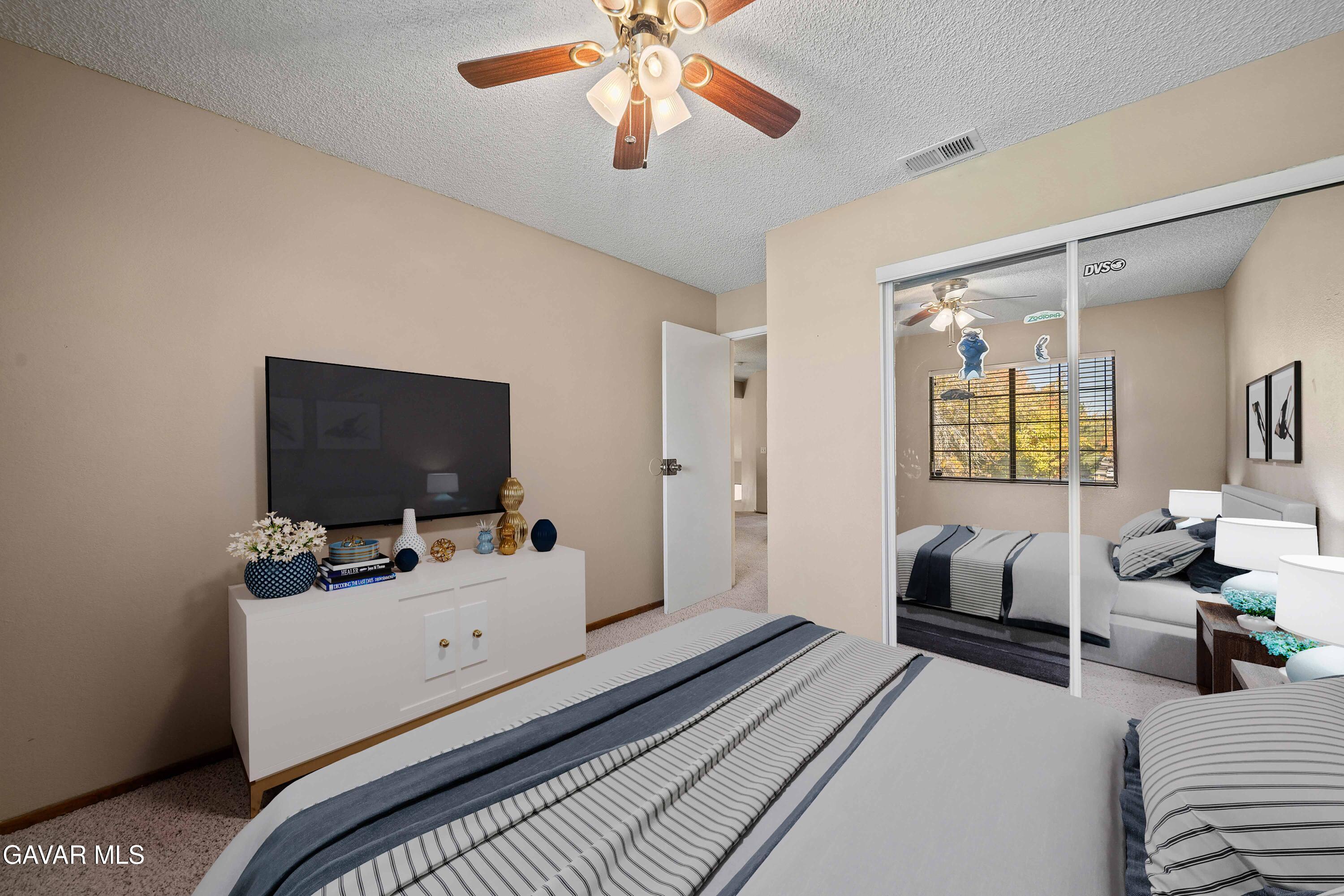 44200 Galion Avenue Lancaster, CA 93536 - Photo 27 of 42 a bedroom with furniture and a flat screen tv