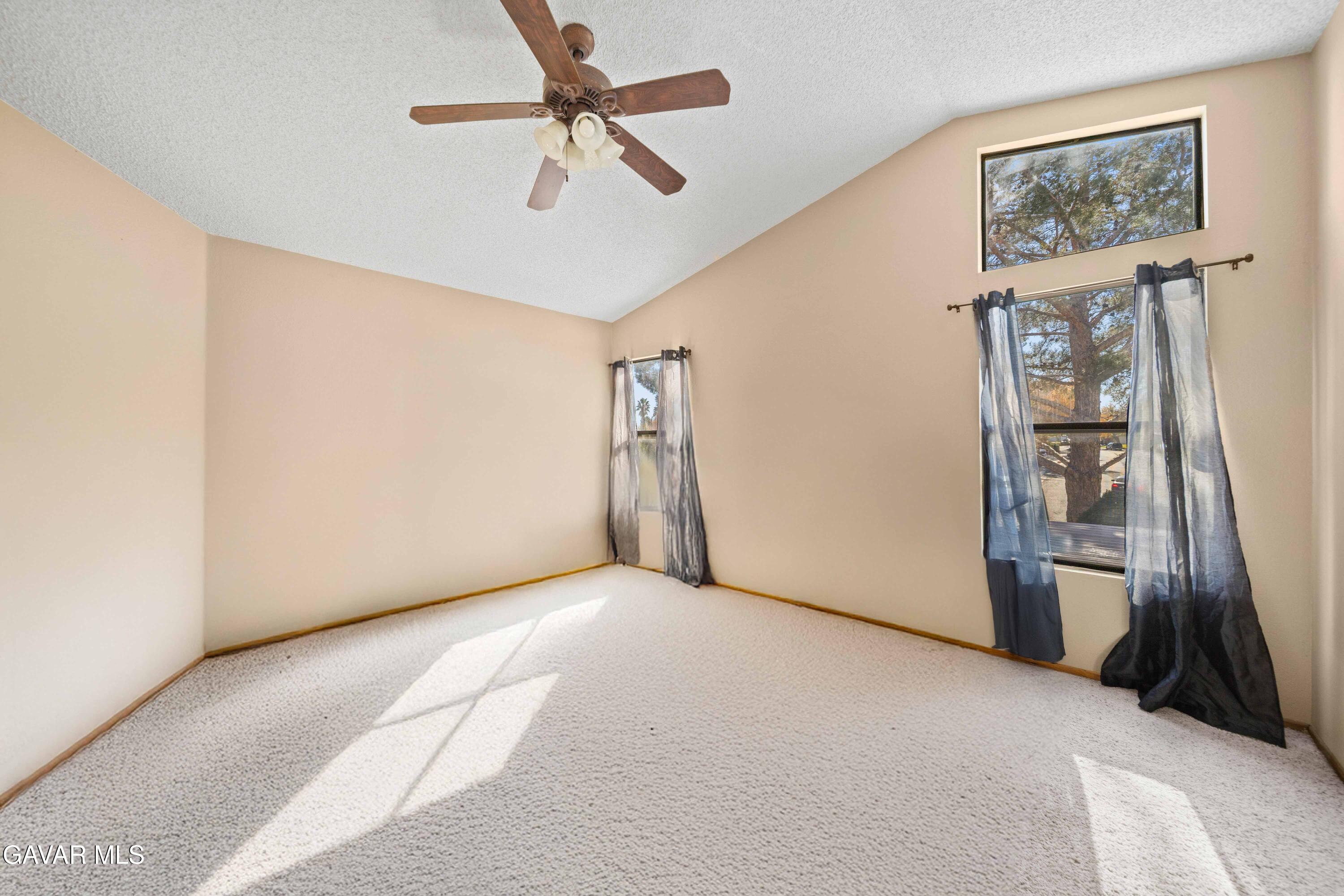 44200 Galion Avenue Lancaster, CA 93536 - Photo 28 of 42 a view of a livingroom with a ceiling fan and window