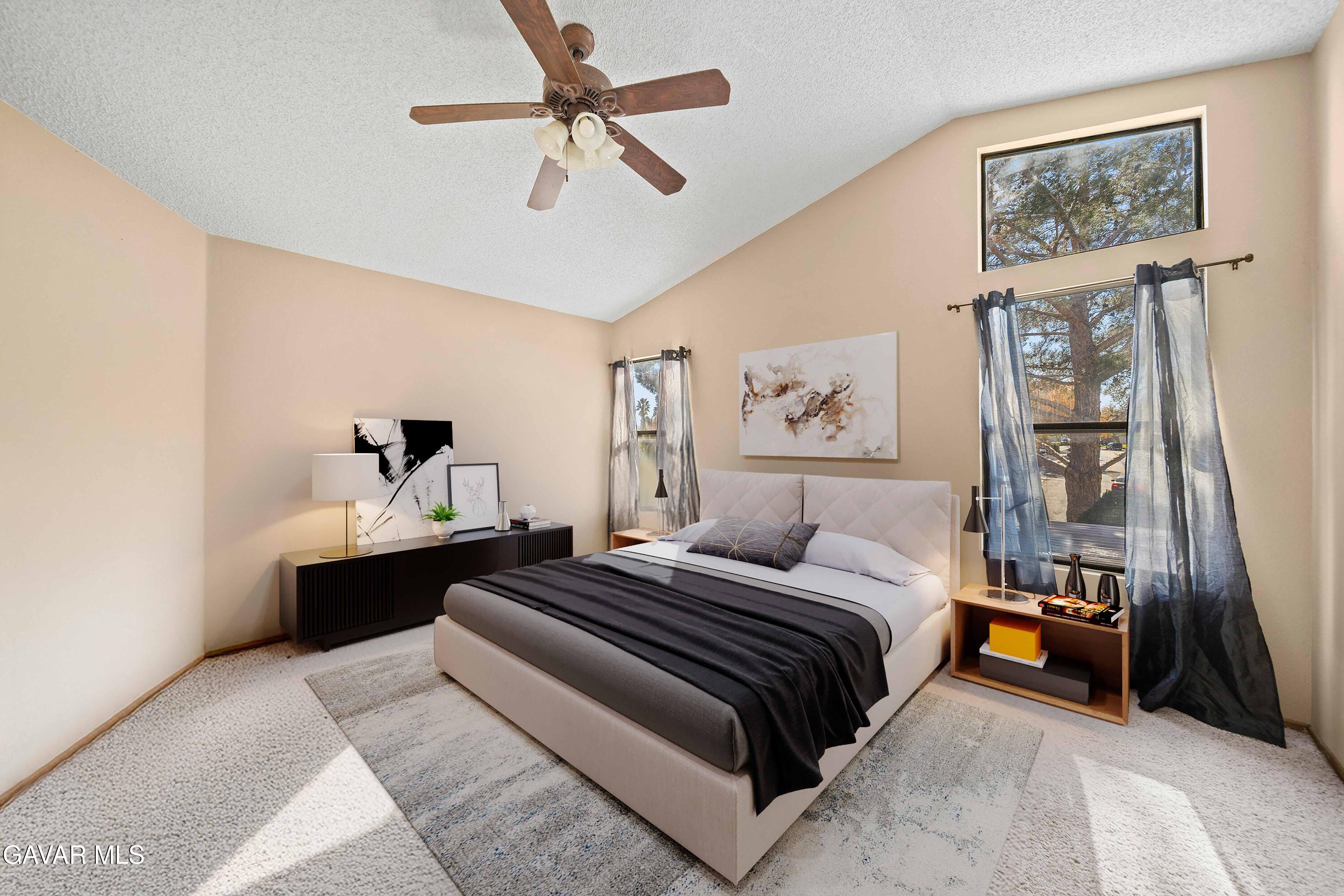 44200 Galion Avenue Lancaster, CA 93536 - Photo 29 of 42 a bedroom with a bed and ceiling fan