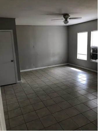 an empty room with windows and entrance