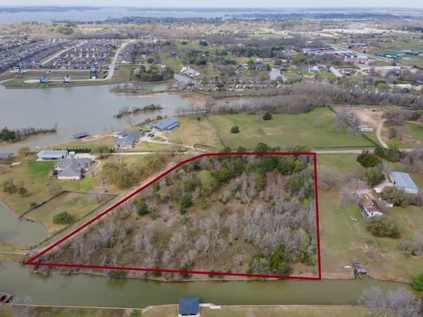 an aerial view of a house with a lake view