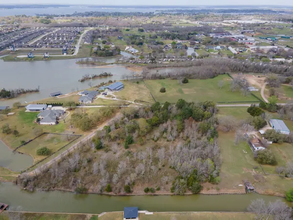 an aerial view of lake residential houses with outdoor space and swimming pool