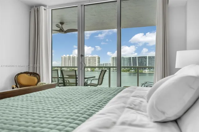 a bedroom with a bed and glass windows