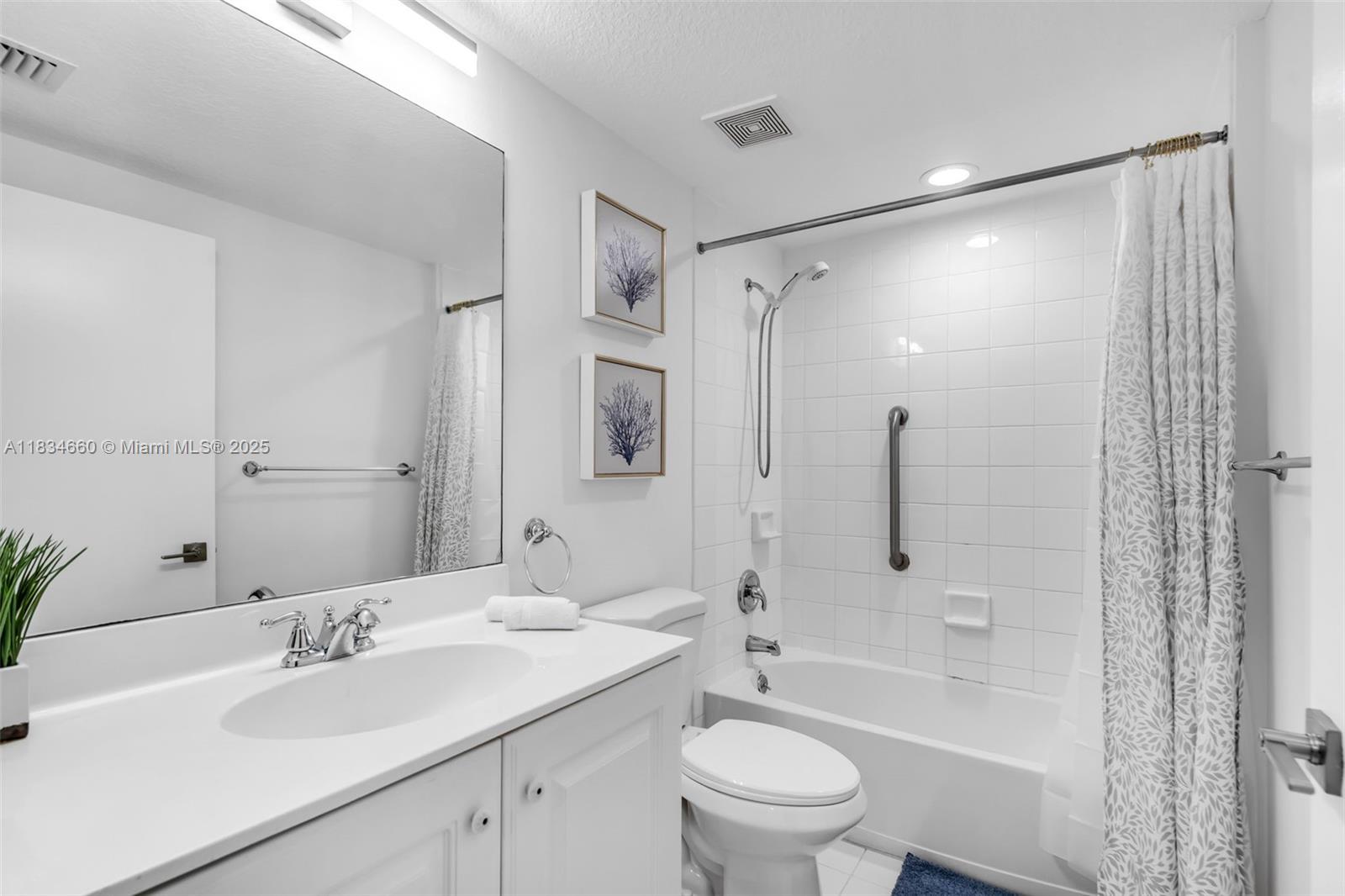 18100 North Bay Road, Unit 709 Sunny Isles Beach, FL 33160 - Photo 21 of 33 a bathroom with a sink toilet and shower
