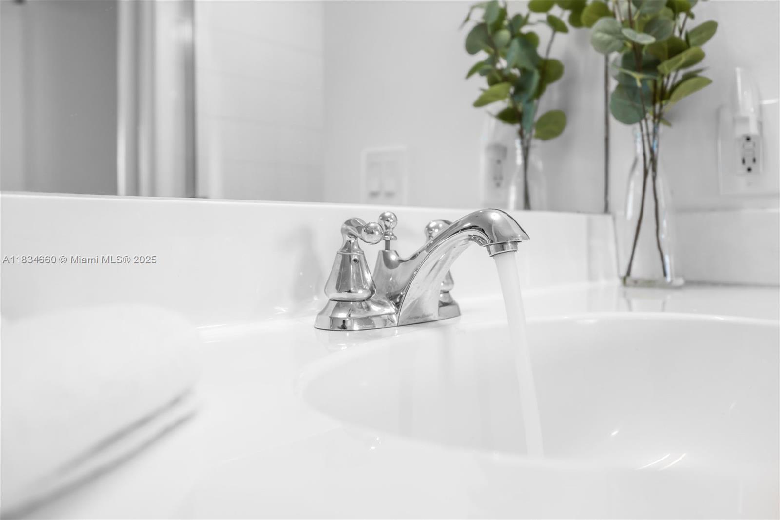 18100 North Bay Road, Unit 709 Sunny Isles Beach, FL 33160 - Photo 23 of 33 a vase of flowers sitting on a table