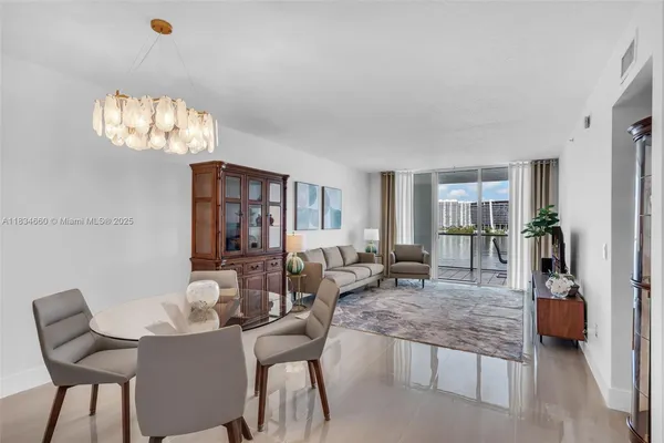 a living room with furniture and a chandelier