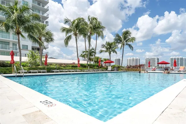 a view of a swimming pool and lounge chairs