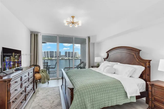 a bedroom with a bed and a chandelier