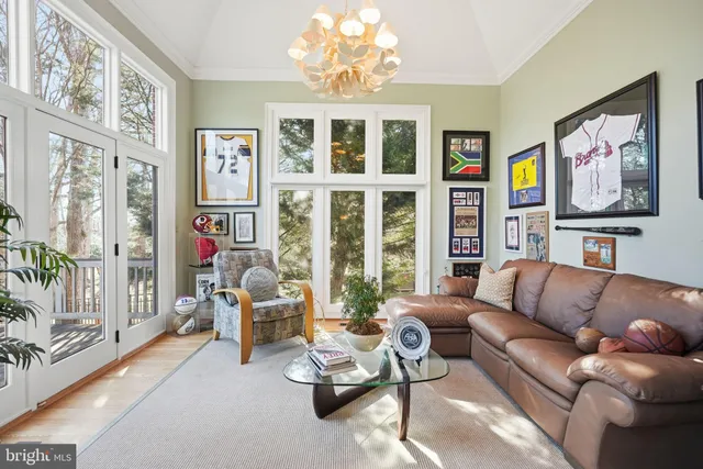 a living room with furniture fireplace and a large window