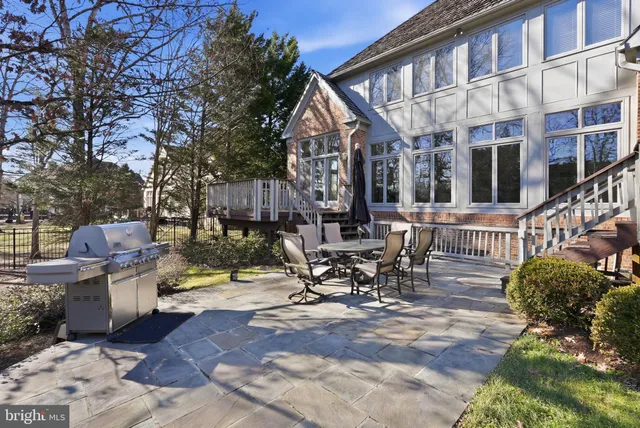 a view of a patio with table and chairs and potted plants