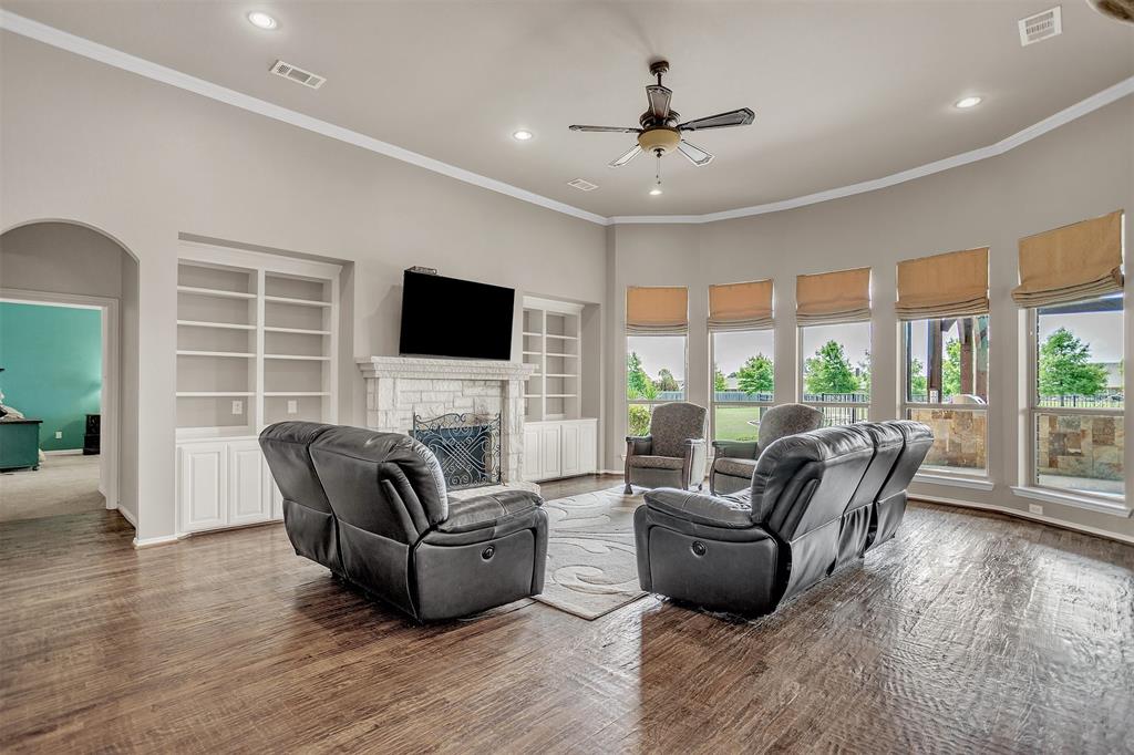 12286 Emerald Ranch Lane North Forney, TX 75126 - Photo 15 of 40 a living room with furniture floor to ceiling window hardwood floor and a flat screen tv