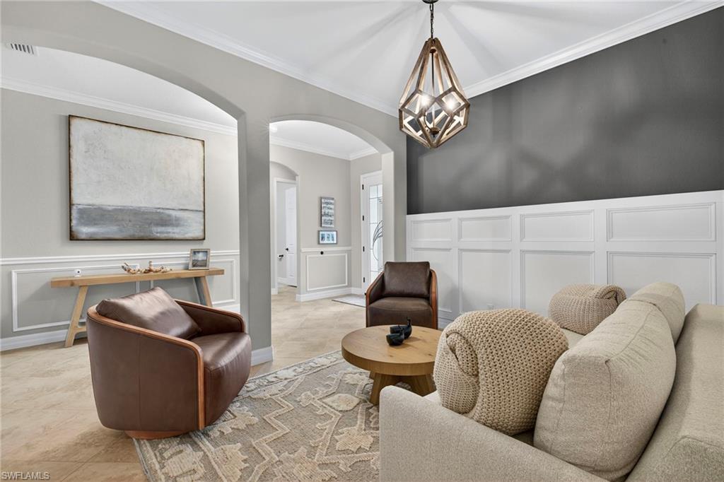 9352 Vercelli Court Naples, FL 34113 - Photo 11 of 49 a living room with furniture and a chandelier