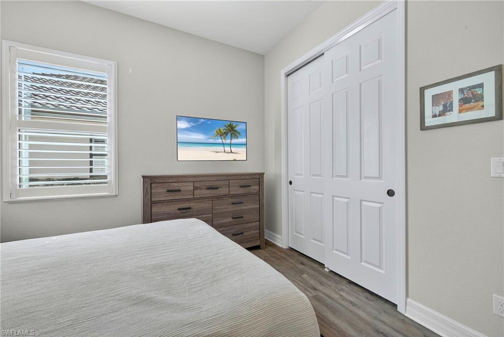 9352 Vercelli Court Naples, FL 34113 - Photo 30 of 49 a bedroom with a bed and a window