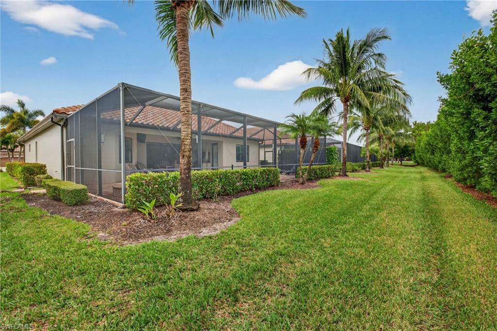 9352 Vercelli Court Naples, FL 34113 - Photo 39 of 49 a front view of a house with garden