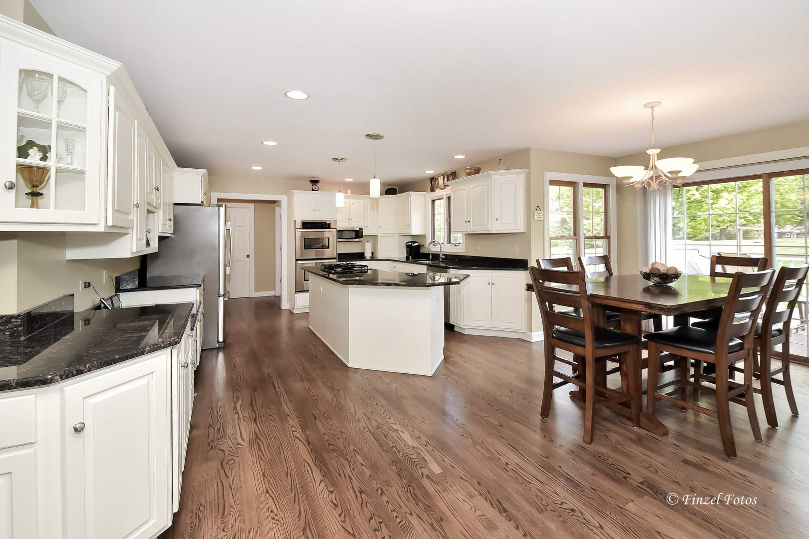 7N355 Ridge Line Road St. Charles, IL 60175 - Photo 8 of 38 a kitchen with stainless steel appliances granite countertop wooden floor a dining table chairs and granite counter tops