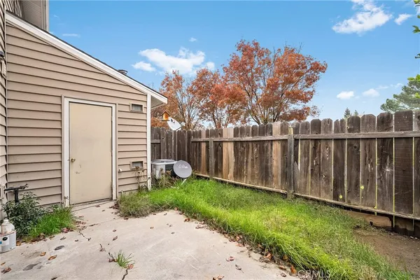 a view of a backyard with a fence and plants
