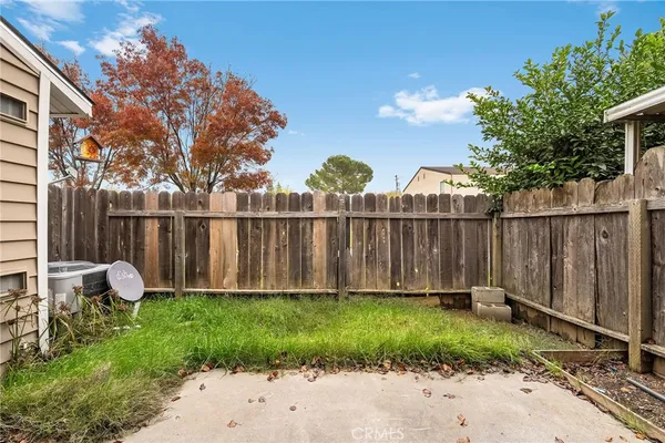 a view of a house with a door and wooden fence