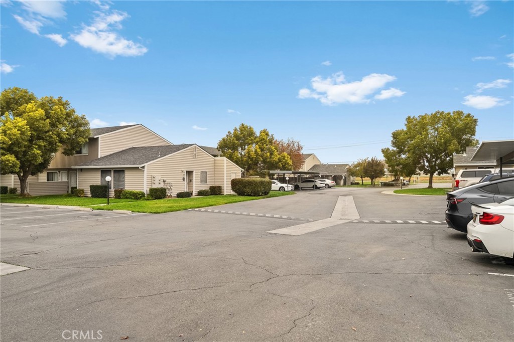585 North Street Corning, CA 96021 - Photo 34 of 41 a view of a white house with a big yard and large trees