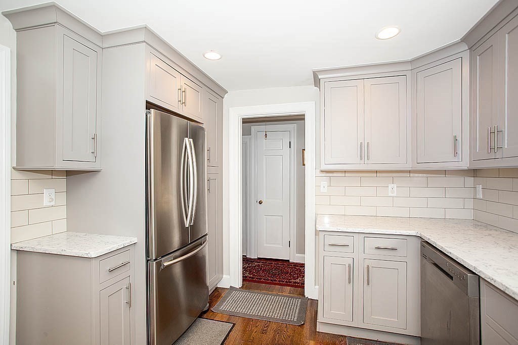10 Standish Road Milton, MA 02186 - Photo 14 of 27 a kitchen with white cabinets and refrigerator