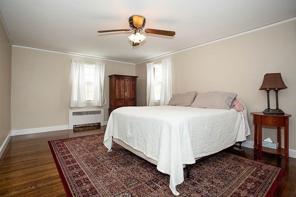 10 Standish Road Milton, MA 02186 - Photo 19 of 27 a spacious bedroom with a bed and a lamp on a rug