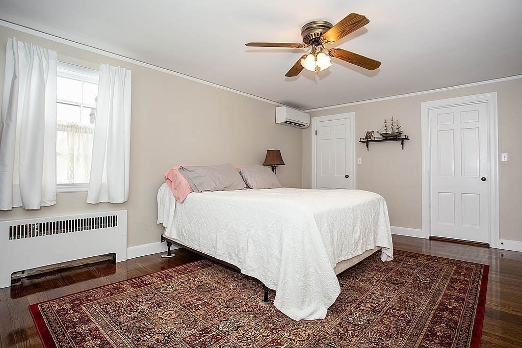 10 Standish Road Milton, MA 02186 - Photo 20 of 27 a bedroom with a bed and a chandelier