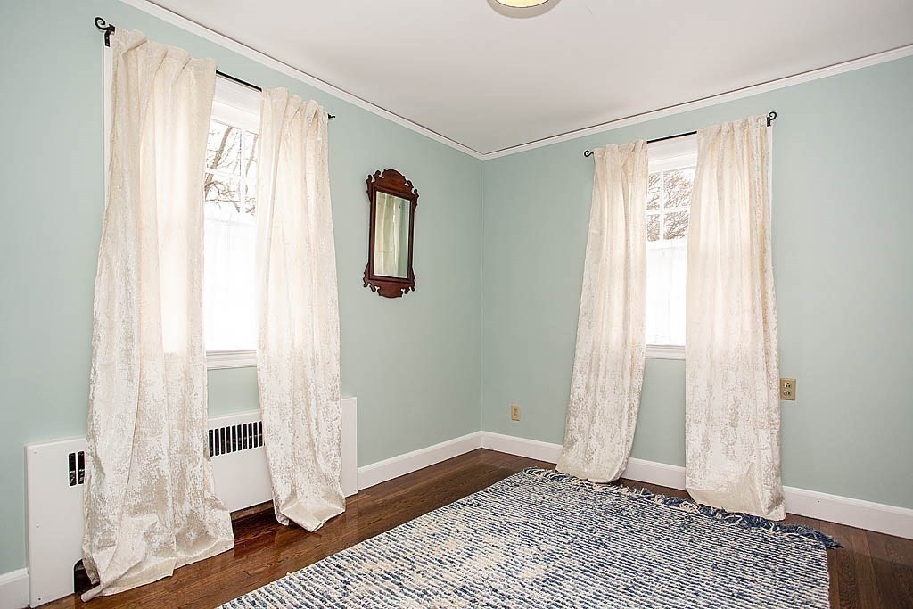 10 Standish Road Milton, MA 02186 - Photo 22 of 27 a view of a bedroom with wooden floor and windows