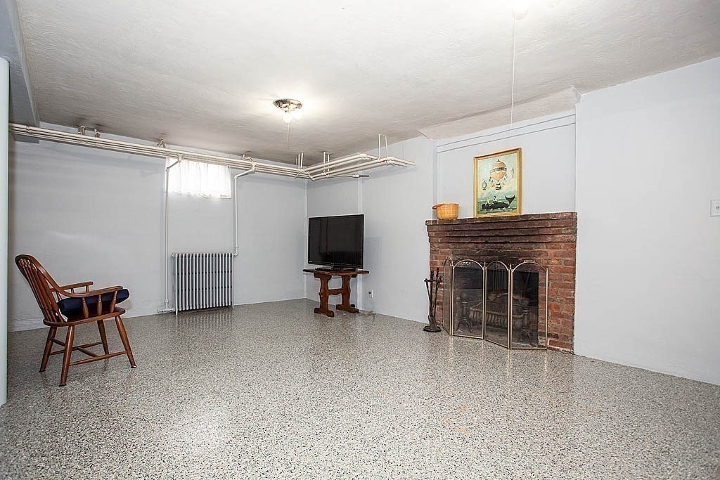 10 Standish Road Milton, MA 02186 - Photo 25 of 27 a view of a livingroom with furniture and a flat screen tv