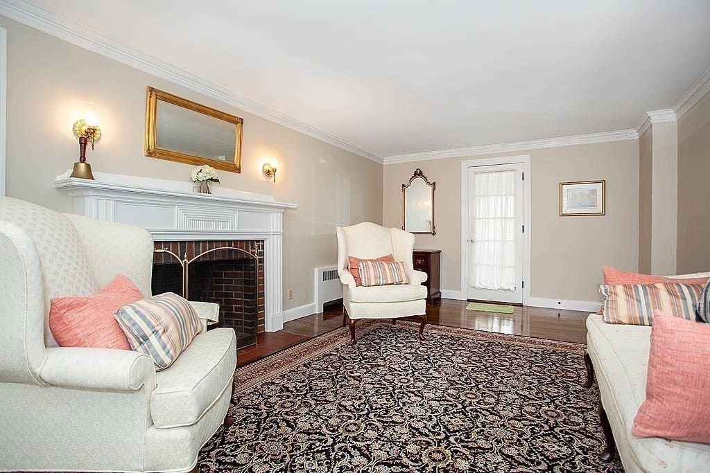 10 Standish Road Milton, MA 02186 - Photo 7 of 27 a living room with furniture and a fireplace