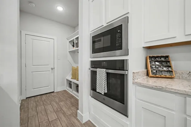 a kitchen with stainless steel appliances granite countertop a stove microwave and cabinets