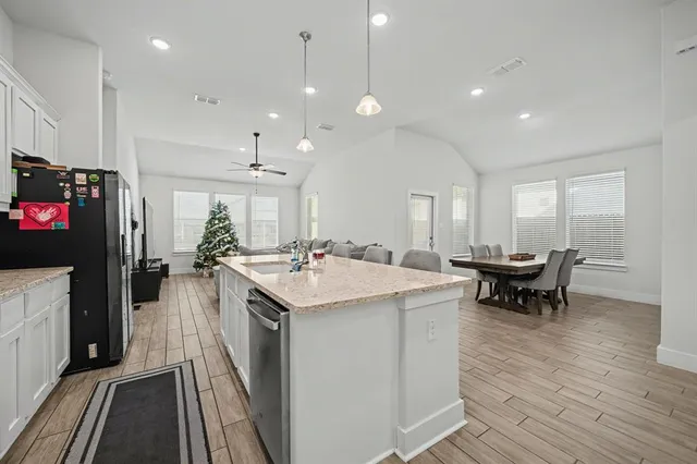 a kitchen with a sink a counter space and stainless steel appliances