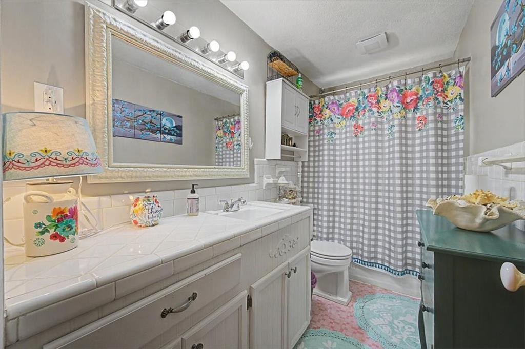 71 North Avery Road Northwest Rome, GA 30165 - Photo 21 of 42 a bathroom with a sink mirror vanity and toilet