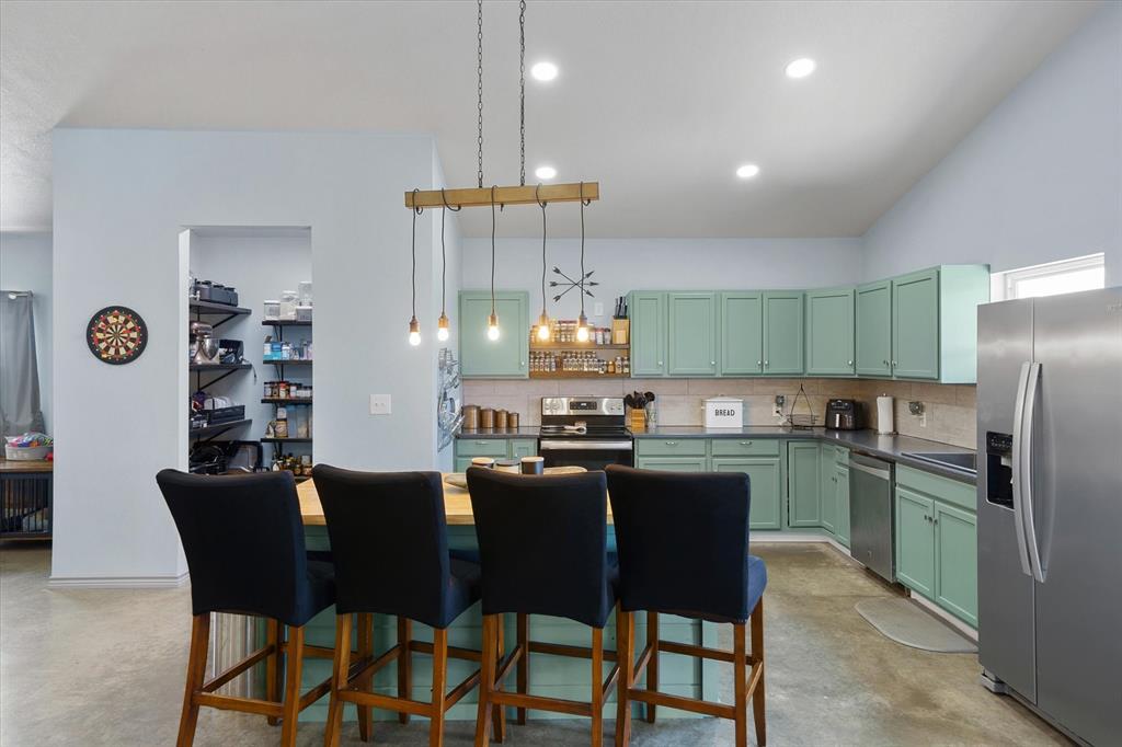 1026 VZ County Road Canton, TX 75103 - Photo 25 of 40 a kitchen with a dining table chairs cabinets and appliances