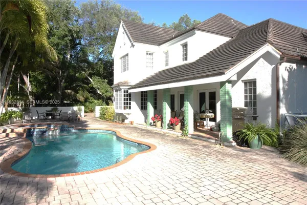 a view of a house with backyard porch and sitting area