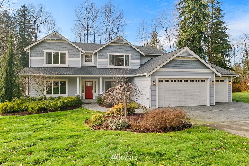 3402 Walsh Road Snohomish, WA 98290 - Photo 1 of 33 a front view of a house with a yard and garage