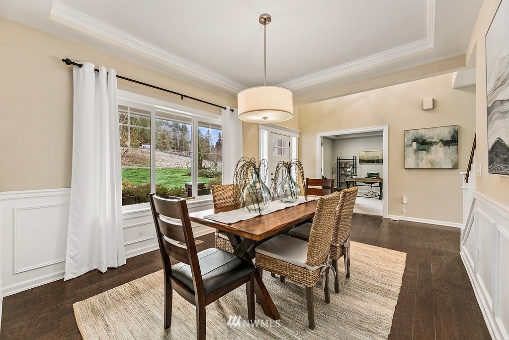 3402 Walsh Road Snohomish, WA 98290 - Photo 4 of 33 a dining room with furniture a chandelier and wooden floor