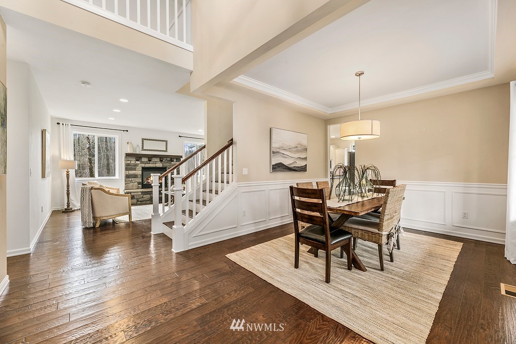 3402 Walsh Road Snohomish, WA 98290 - Photo 5 of 33 a dining room with furniture a chandelier and wooden floor
