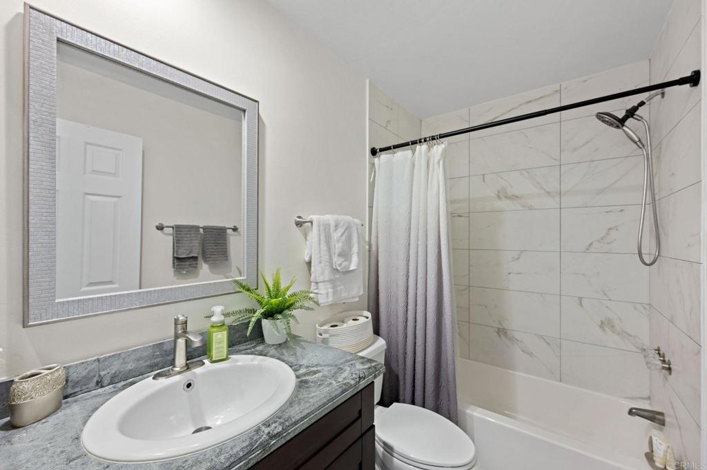 3681 Harvard Drive Oceanside, CA 92056 - Photo 15 of 30 a bathroom with a granite countertop sink toilet and shower