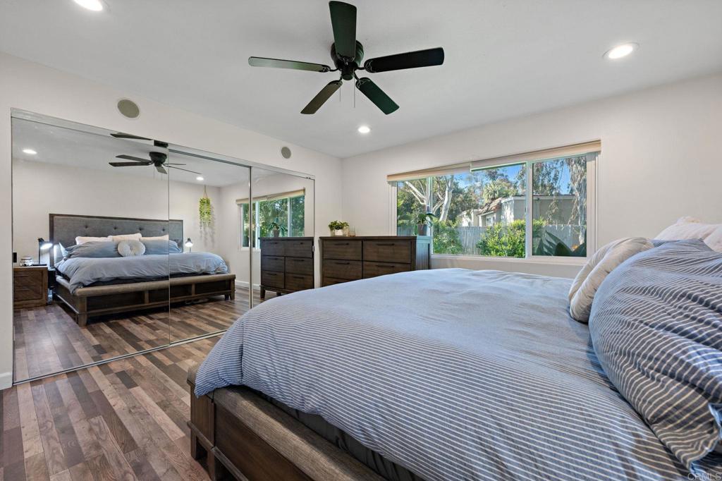 3681 Harvard Drive Oceanside, CA 92056 - Photo 17 of 30 a bedroom with a bed a window and a chandelier