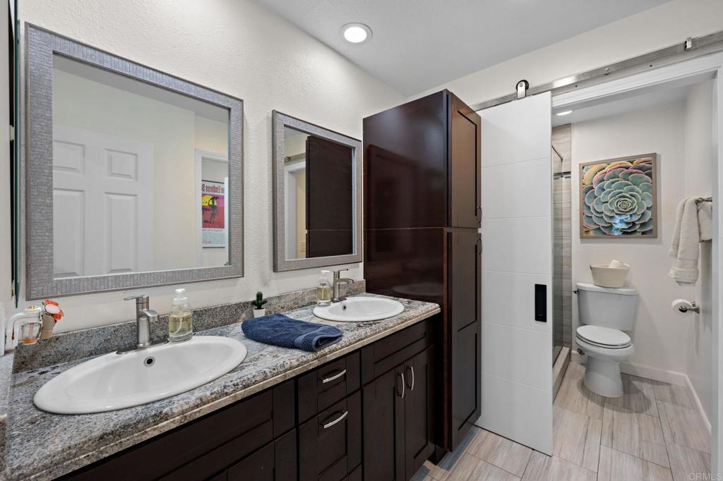 3681 Harvard Drive Oceanside, CA 92056 - Photo 18 of 30 a bathroom with a granite countertop sink toilet and shower