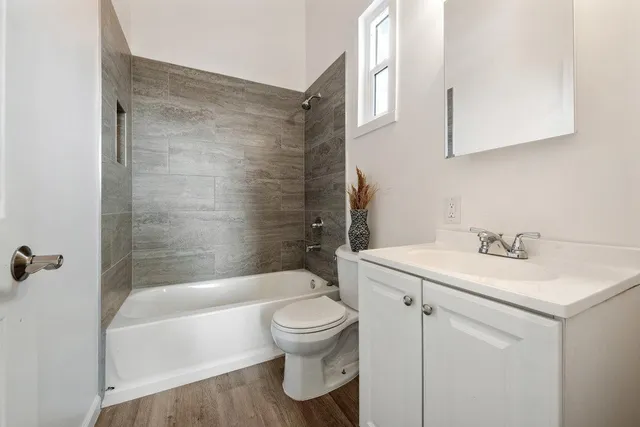 a bathroom with a sink toilet and shower