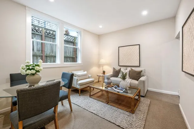 a living room with furniture and a potted plant