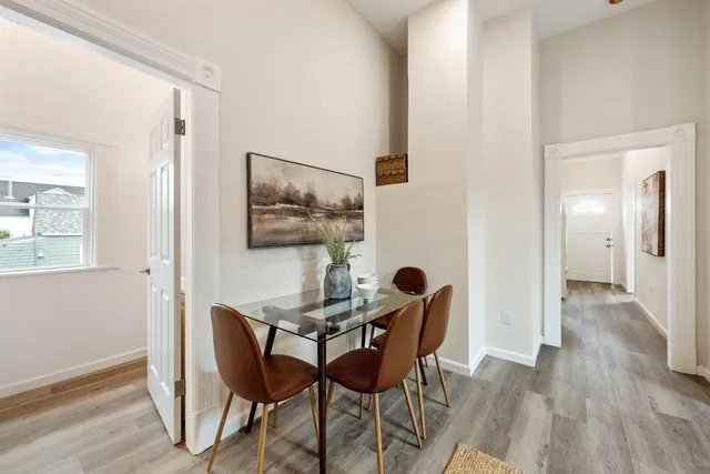 a dining room with furniture and wooden floor